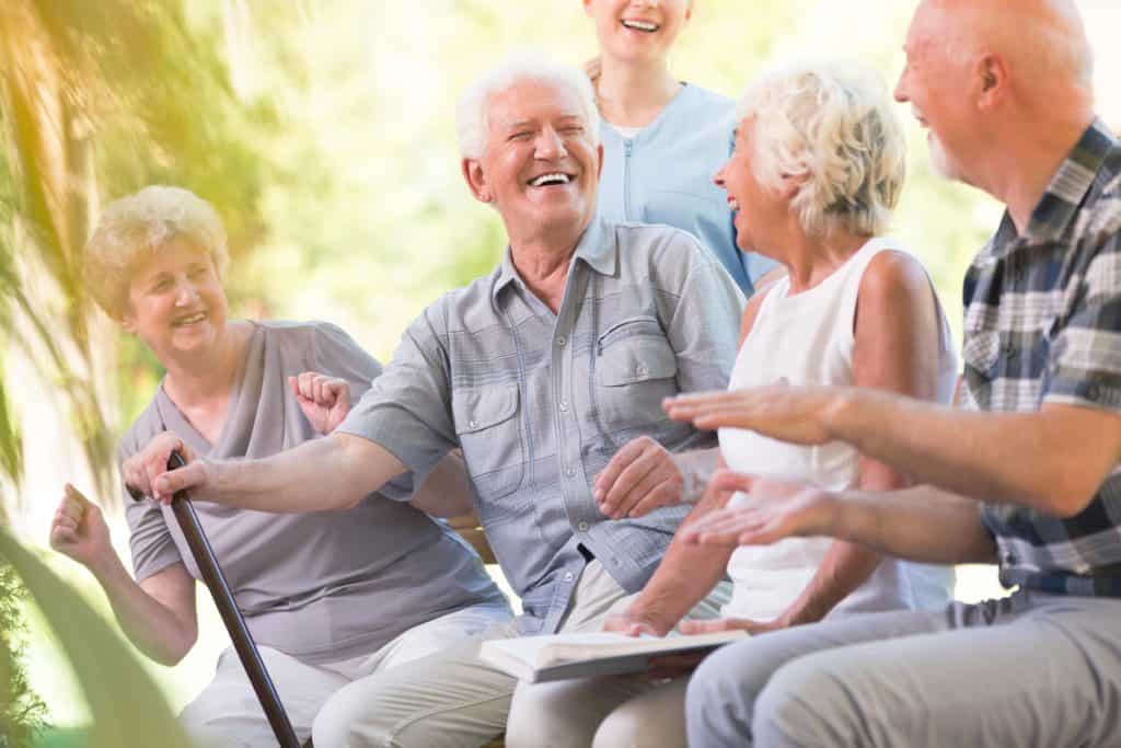 what is assisted living? A group of seniors smiling and enjoying time together
