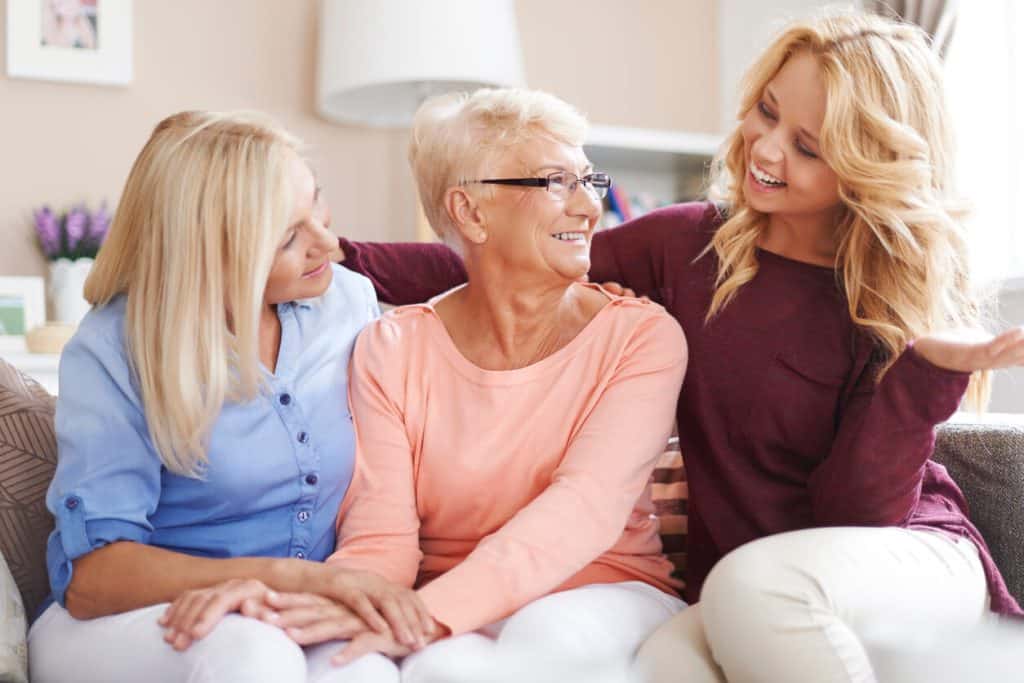 Daughters and senior mom having a good time talking and laughing