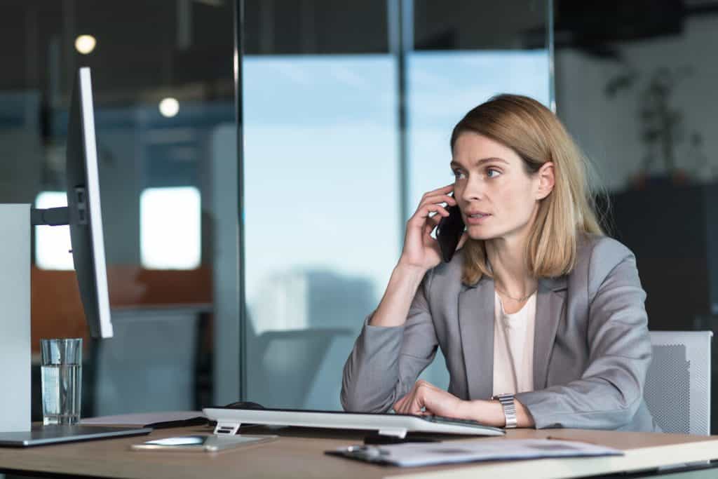 Assisted living for young adults with mental illness: tired looking caregiver calling national helpline on the phone. 2022