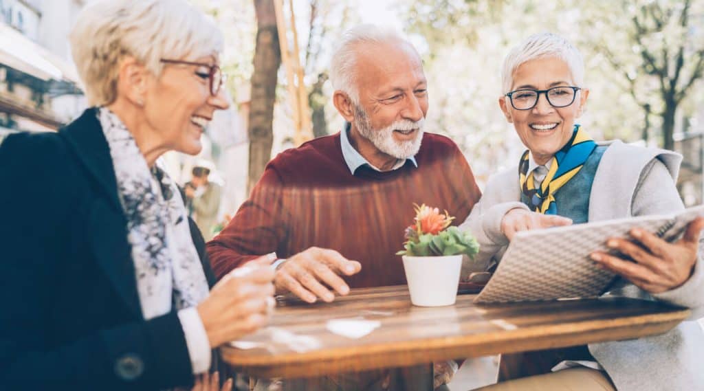 Senior friends enjoying quality time, helped by senior caregiver jobs