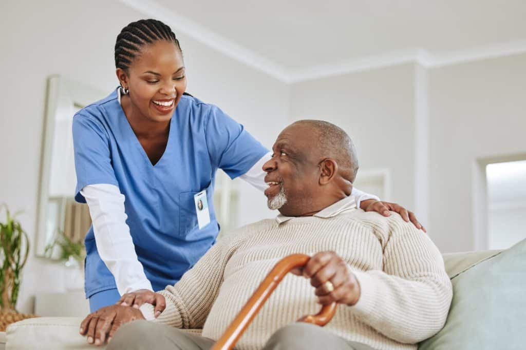 A nurse having a light moment with a senior resident, fulfilling senior caregiving jobs