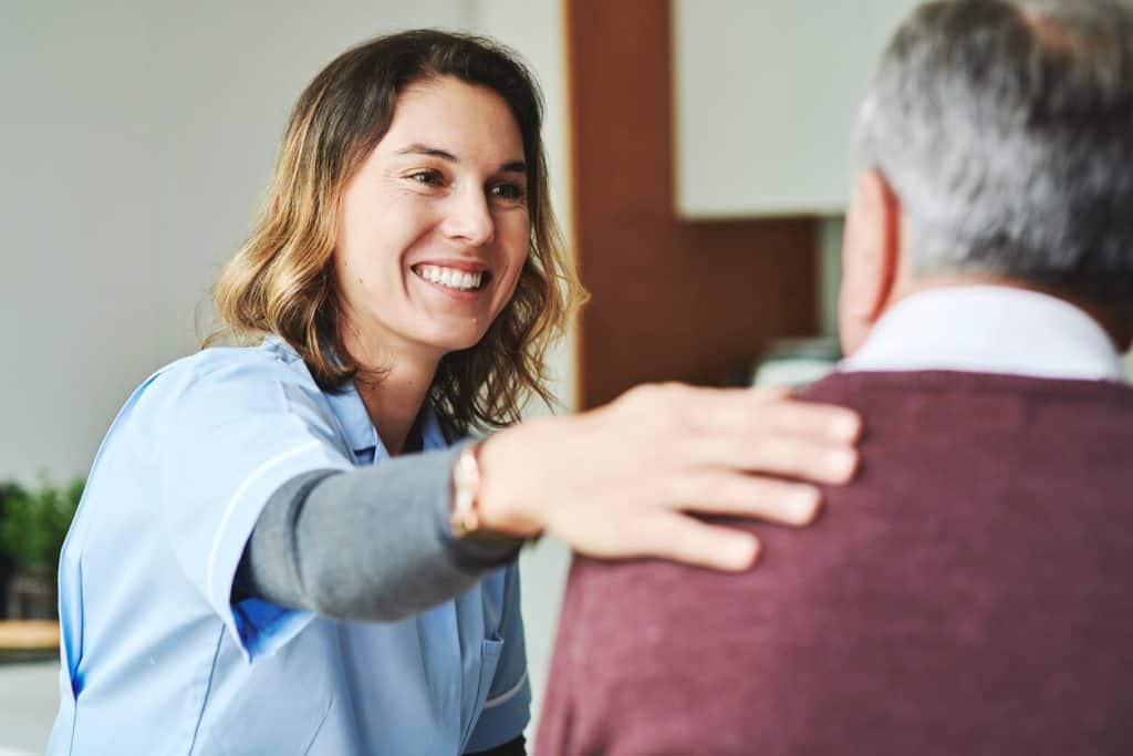 a patient advocate, who holds senior homecare jobs, offering support to an older adult