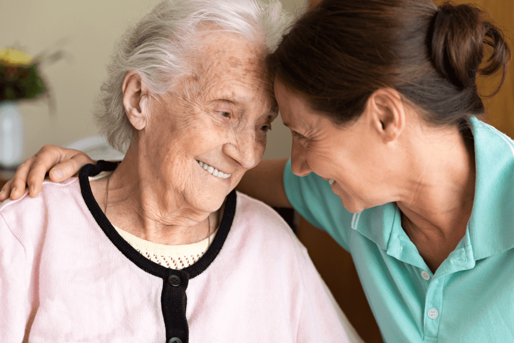 Home Nurse Care: Female caregiver and elderly woman at home