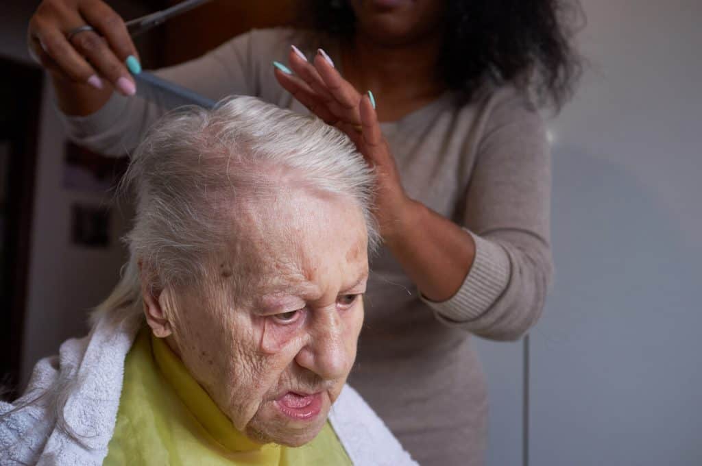 non-medical services woman brushing senior client’s hair privacy. non medical home care agencies