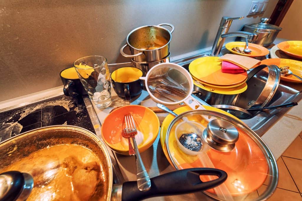 picture of dirty dishes in sink and all over kitchen counters. non medical home care agencies