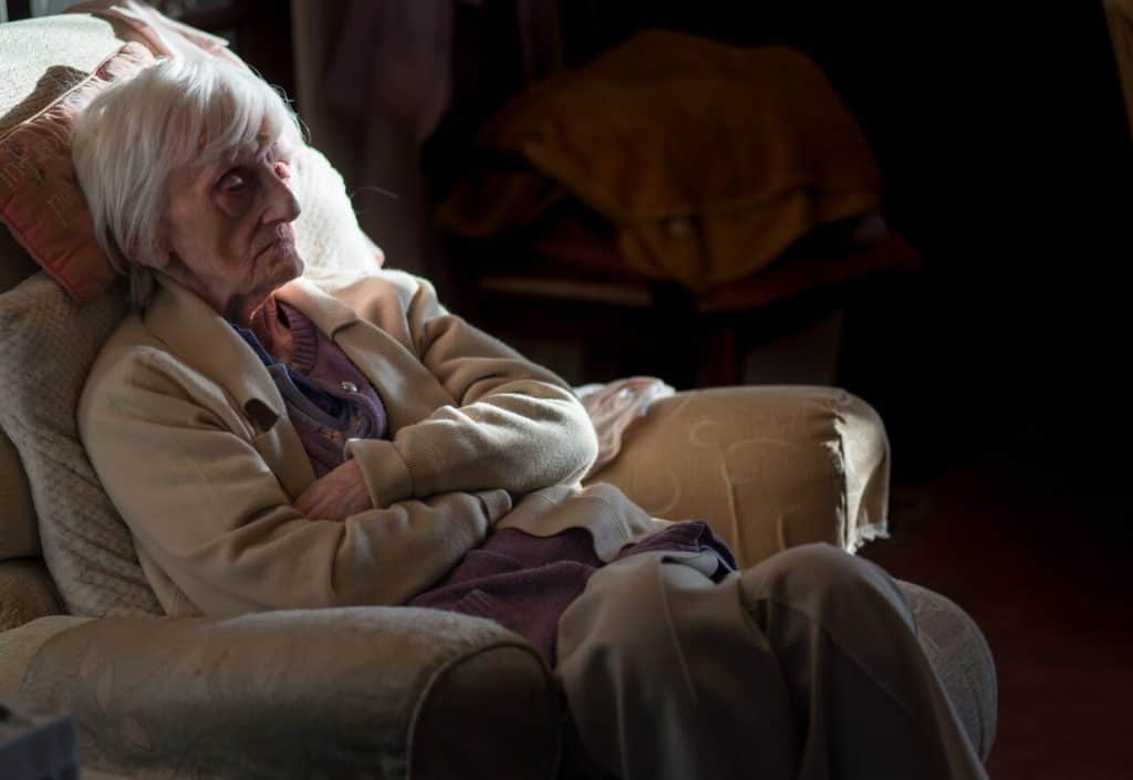 elderly woman with dementia in recliner who looks tired, cold, and isolated, lonely 2022. non medical home care agencies