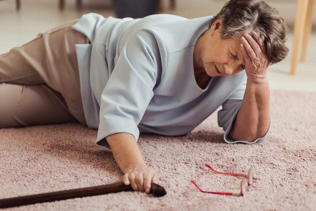 older adult woman with a cane who has fallen on the floor. 24 hour nursing care at home