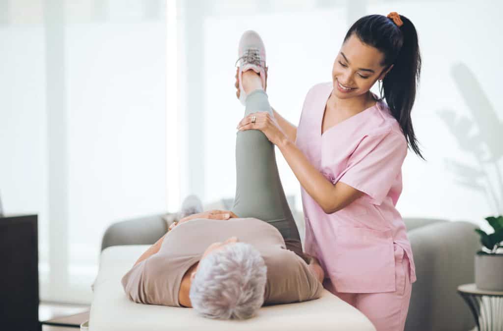 A caregiver assisting an elderly resident with their exercises, caregiver online training