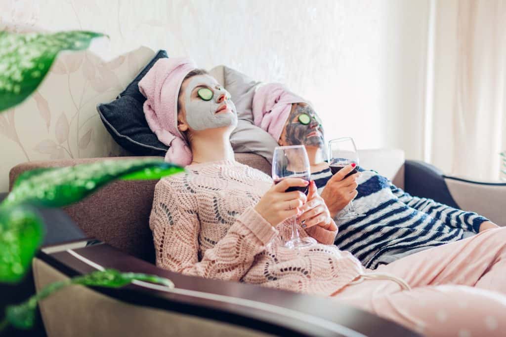 A senior mom and her daughter having facial treatment at home. unique activities for seniors