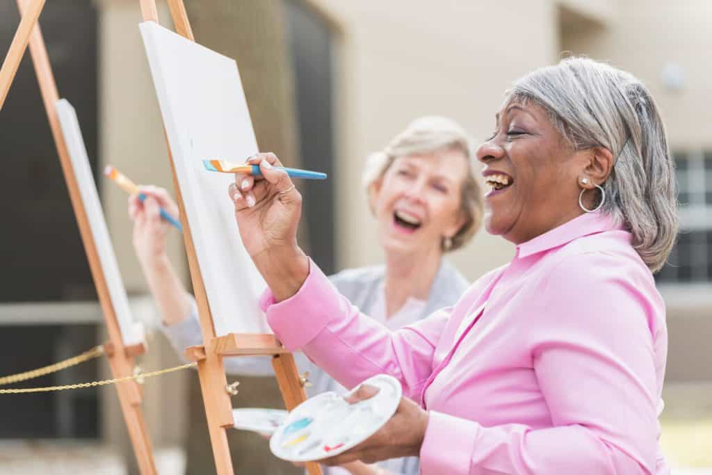 assisted living residents enjoying a painting session. outdoor activities for seniors