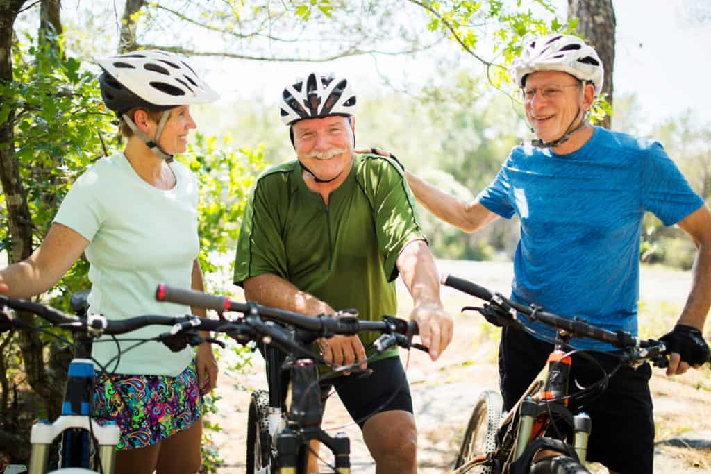 friends enjoying the outdoors on their bikes. outdoor activities for seniors