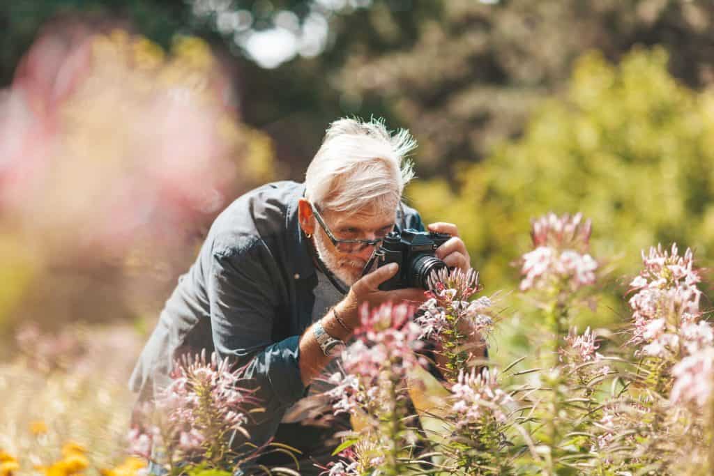 an elderly man enjoying outdoors photography. outdoor activities for seniors