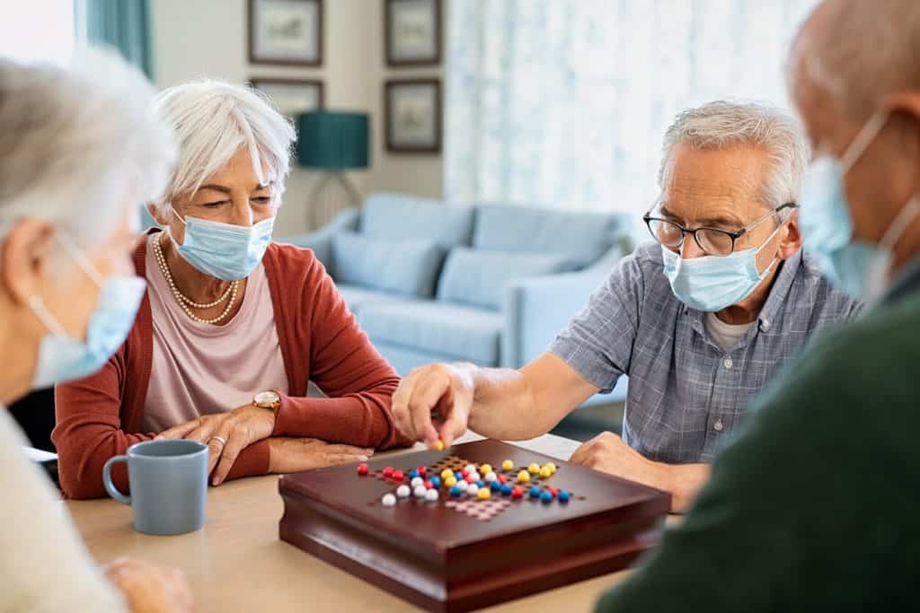 Older people playing checkers, activities for seniors in long term care facilities