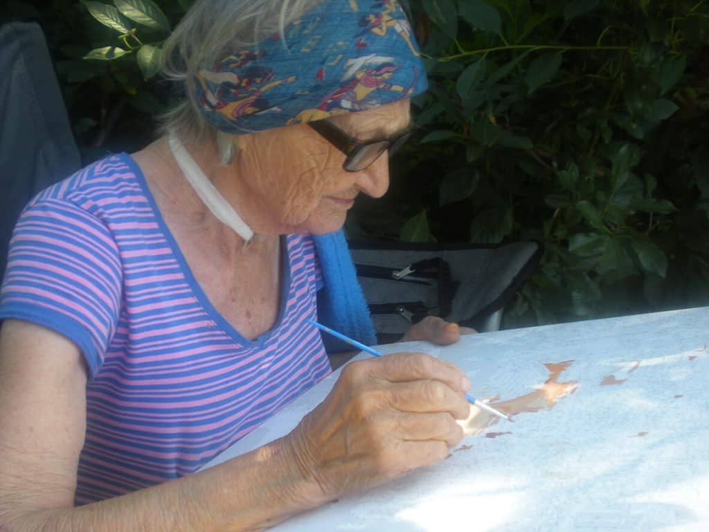 Fun indoor activities for seniors - senior woman coloring in her garden