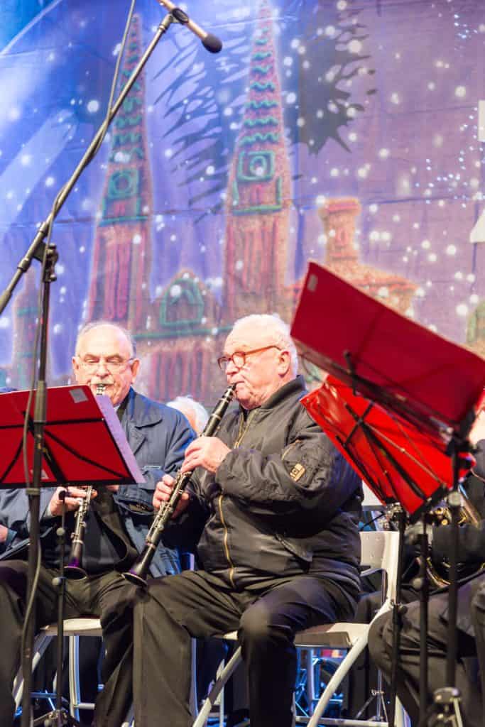 Two Senior men playing instruments in a Christmas concert. christmas activities for seniors