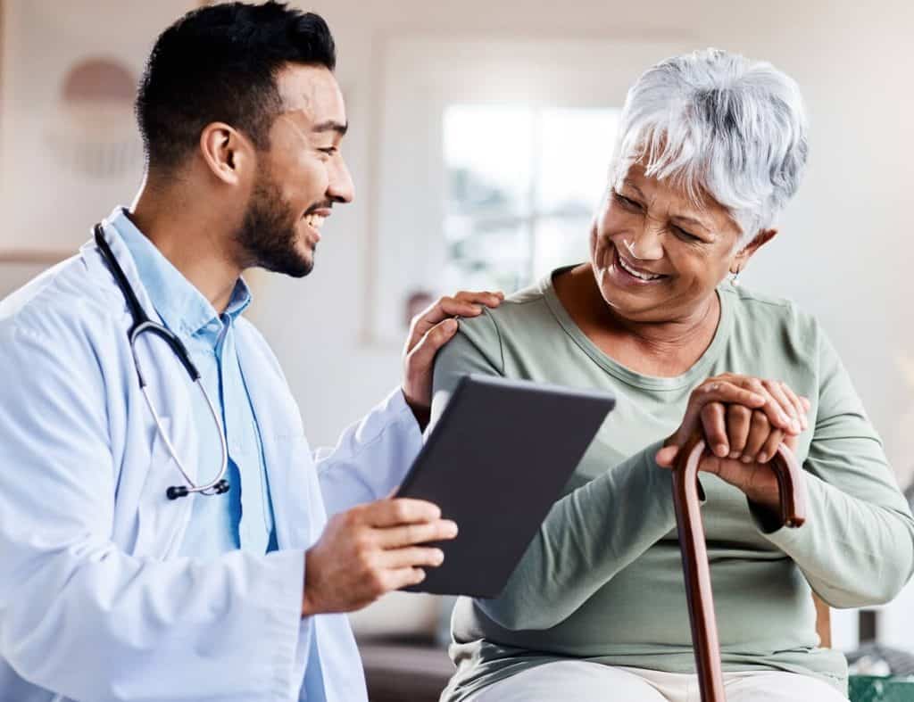 caregiver sharing a light moment with an elderly resident in an assisted living home, questions to ask for assisted living