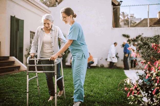 home care aide assists senior woman. aides for home and health care support services