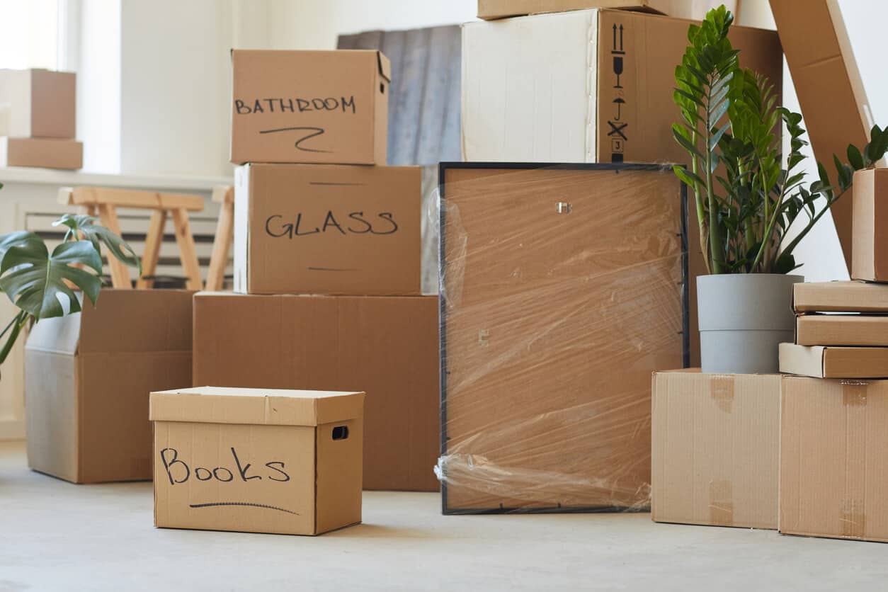 packed boxes to move to a new home, moving into assisted living checklist