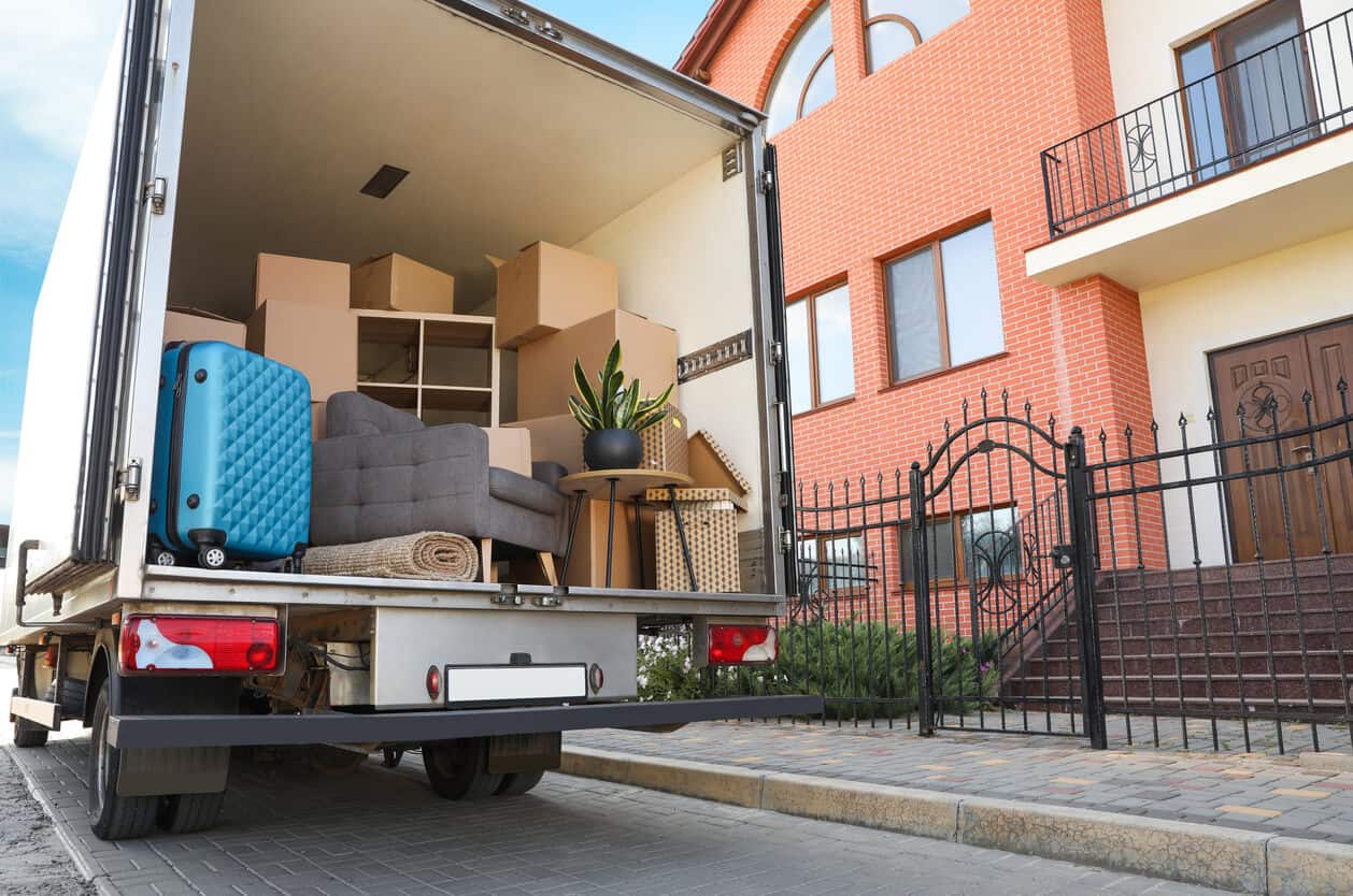 Moving company van full of packed boxes and furniture, moving into assisted living checklist