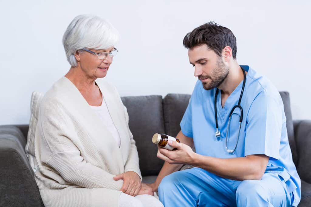 male nurse prescribing drugs to a senior woman at home - nurse for hire
