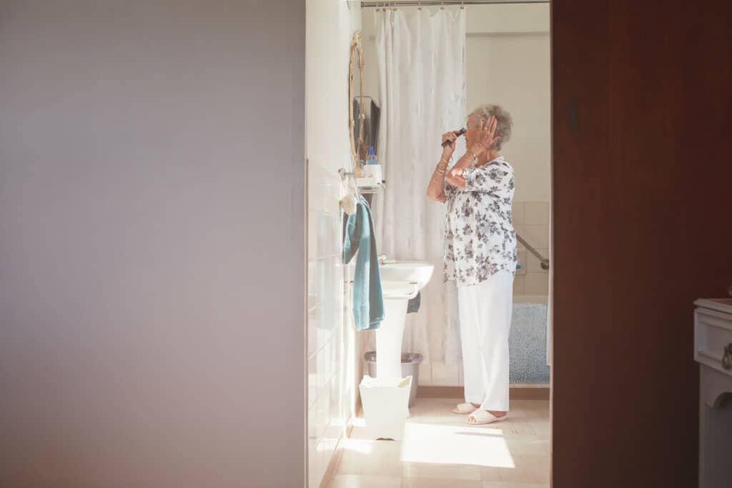 an older woman preparing after taking a shower