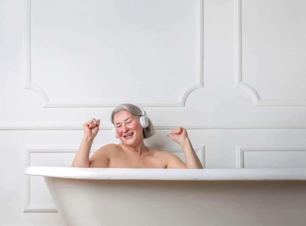 an older woman enjoying her bath after helping with bathing for the elderly