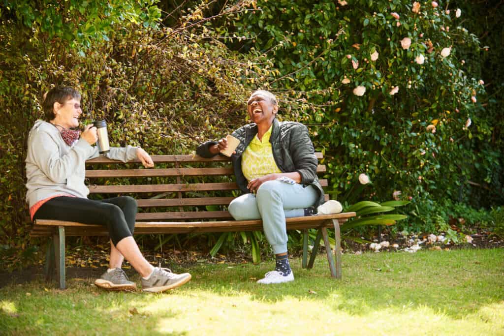 senior care companion having a conversation over coffee