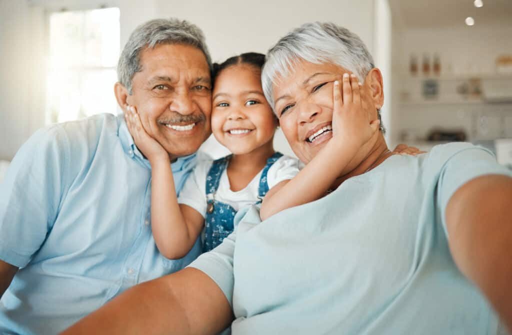 happy grandparents enjoying spending quality time with granddaughter