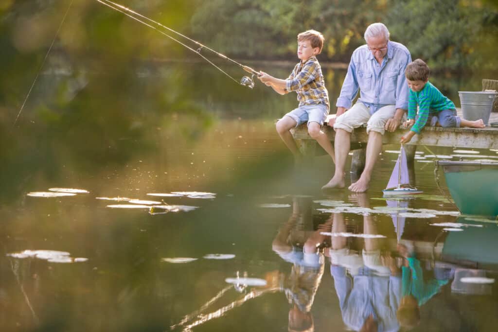 quotes about age and beauty- a grandfather playing and teaching his grandsons fishing