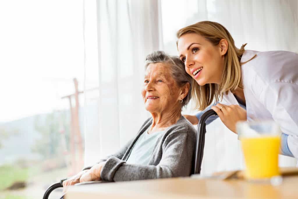 A gerontologist with an elderly woman - what is a gerontologist