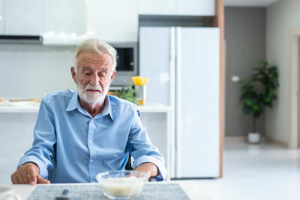 Questions to ask a dietitian about eating disorders. A photo of a depressed male senior patient with anorexia.