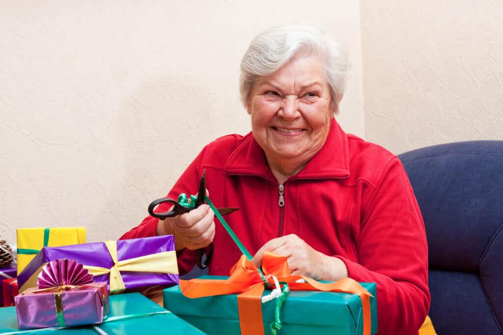 Nation day of joy activities - elderly woman unboxing presents