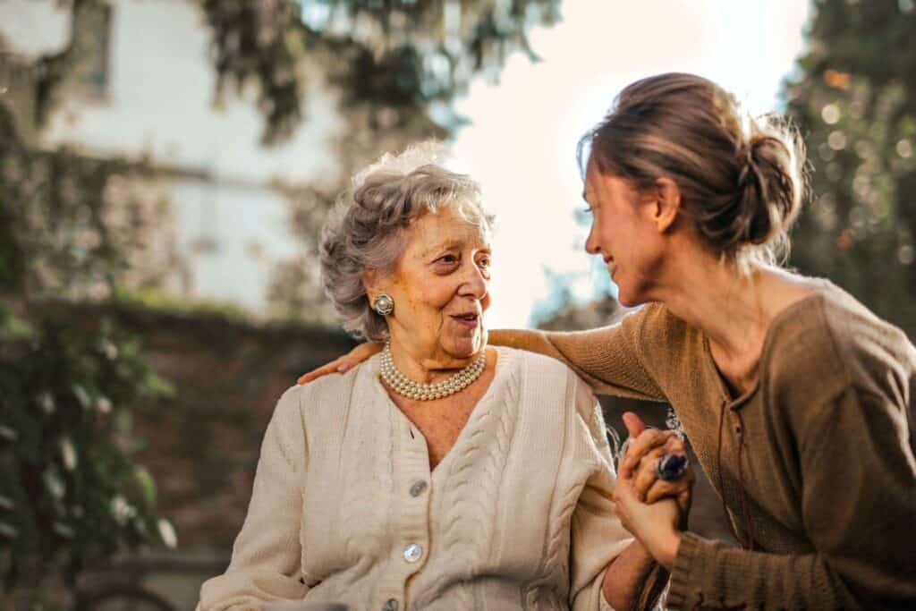 A happy elderly woman talks with a caregiver | sacramento in home support services
