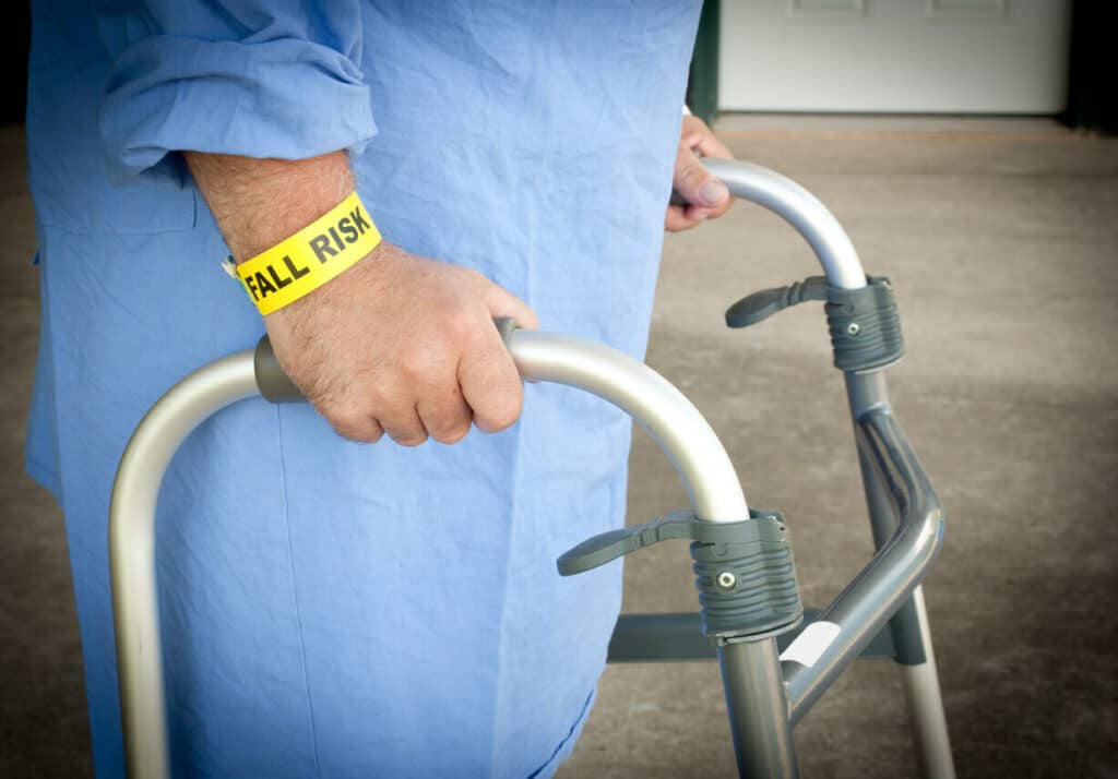 Elderly walking with a cane and is at risk of fall - massage for seniors