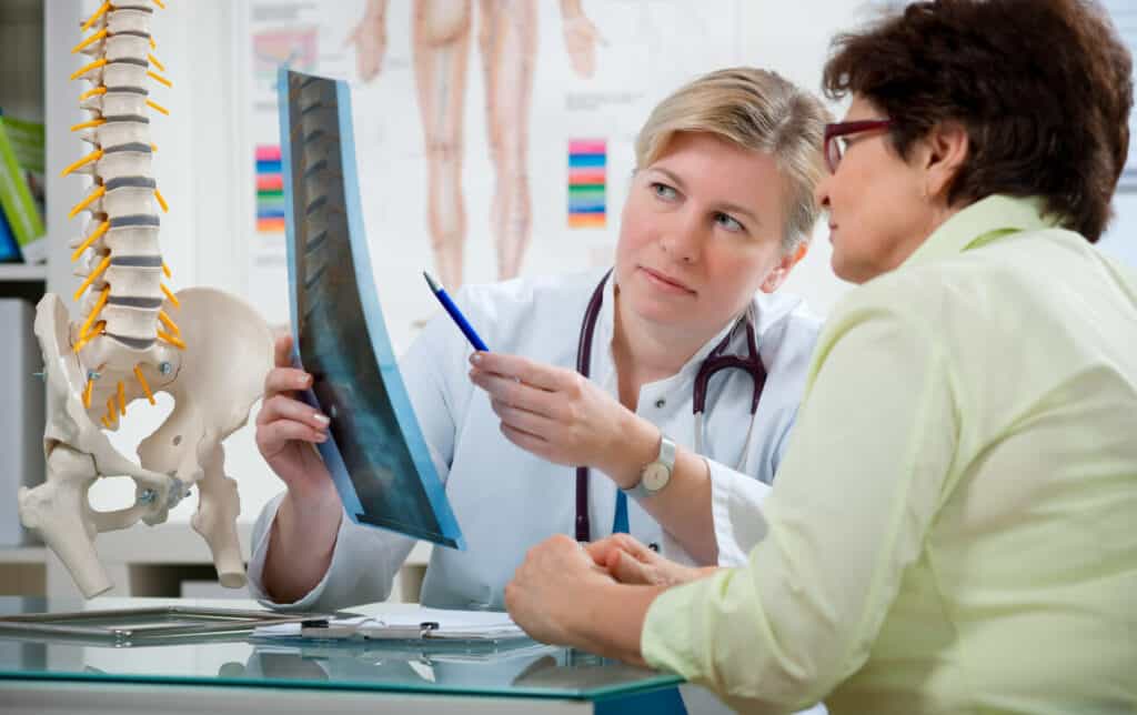 female physical therapist discussing older woman’s x-ray with her - questions to ask physical therapist