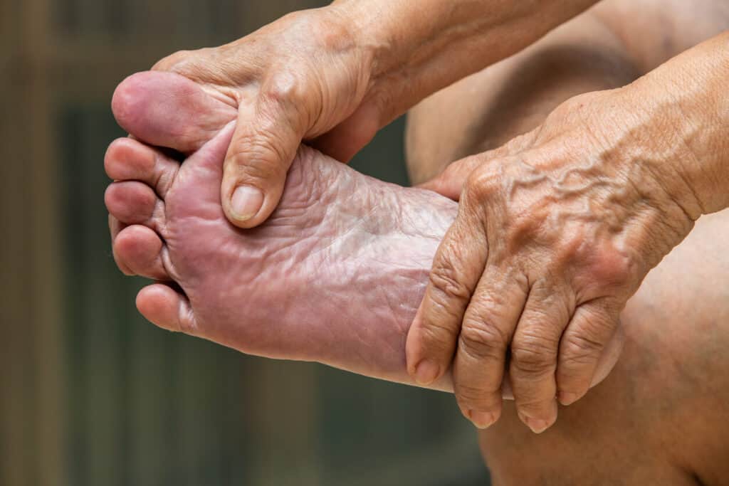 old people’s feet - elderly woman massaging her feet