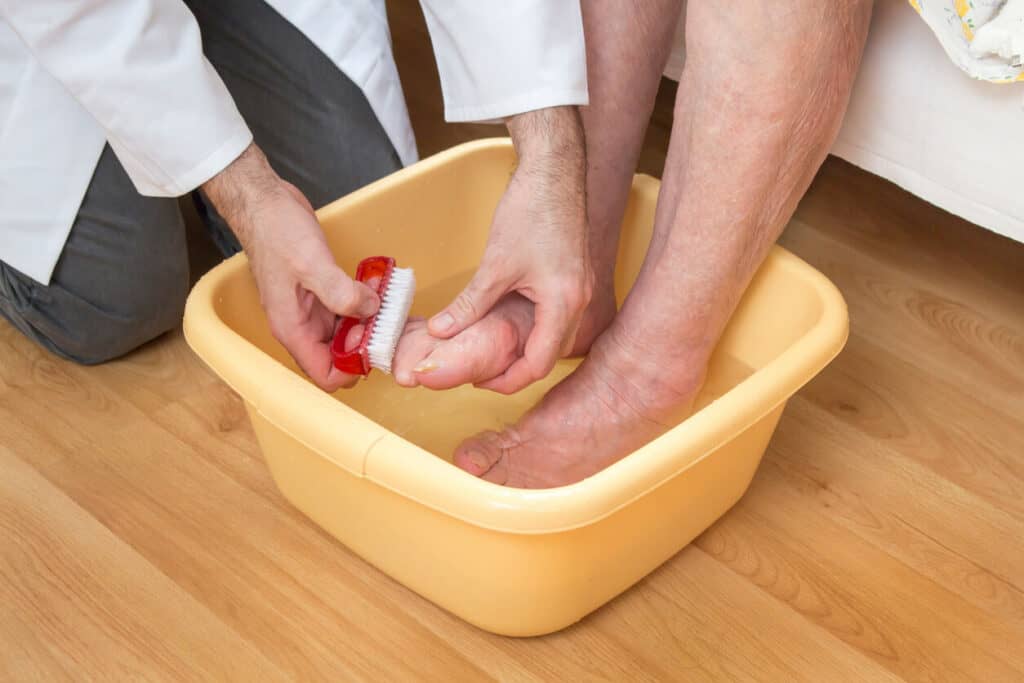 soaking old person foot in water