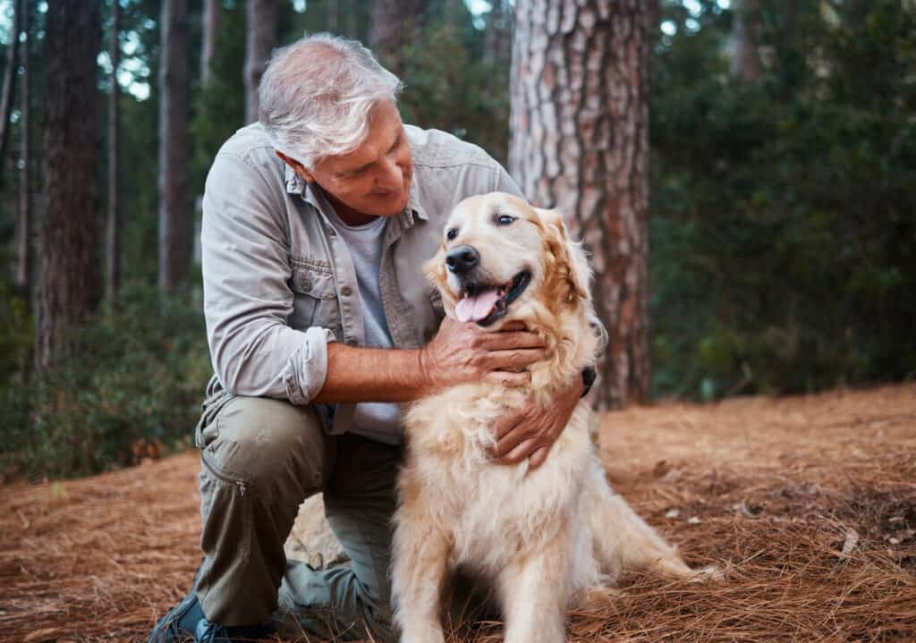 an older man with his Parkinson's service dog