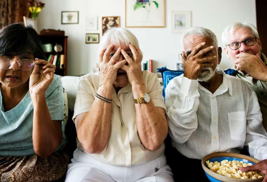 A group of seniors watching too much TV documentaries about crimes and violence.