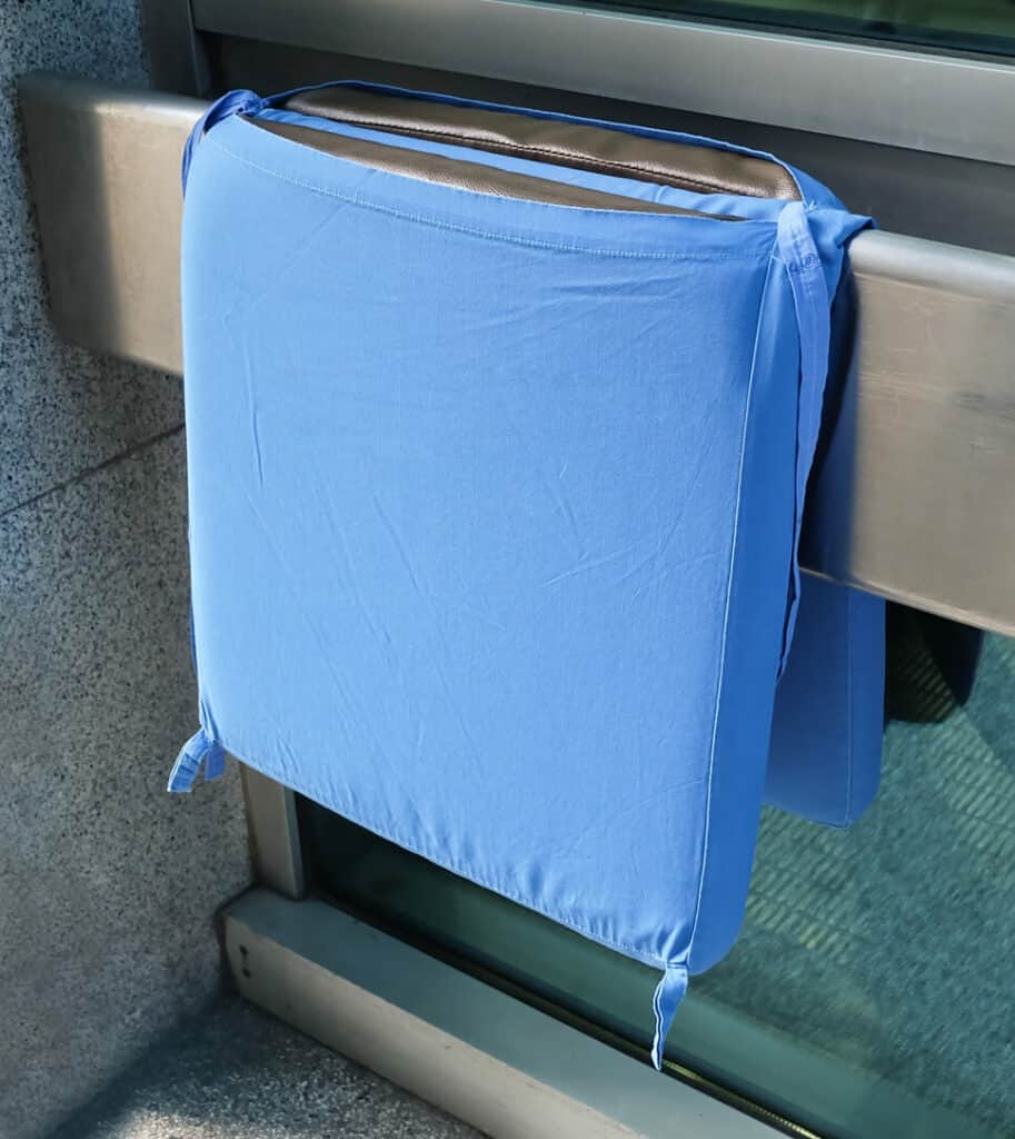 a blue wheelchair cushion to protect an adult from slipping off the wheelchair