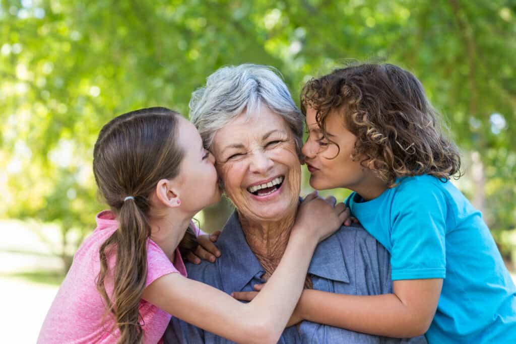 When did Grandparents Day originate - grandkids kissing their grandmother.