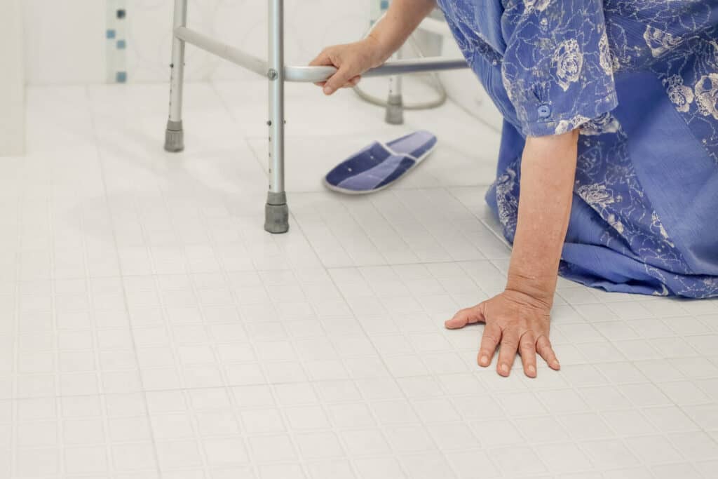 Shower assistance for elderly - a senior woman slipping and falling in the bathroom