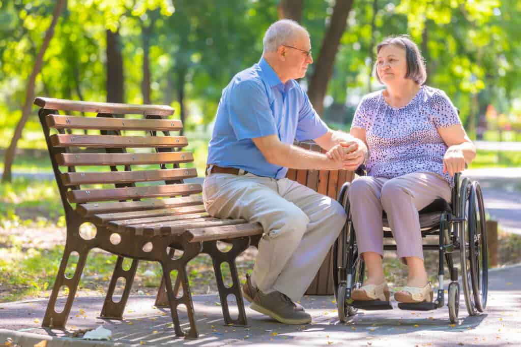 A senior husband caregiver for a wife in a wheelchair