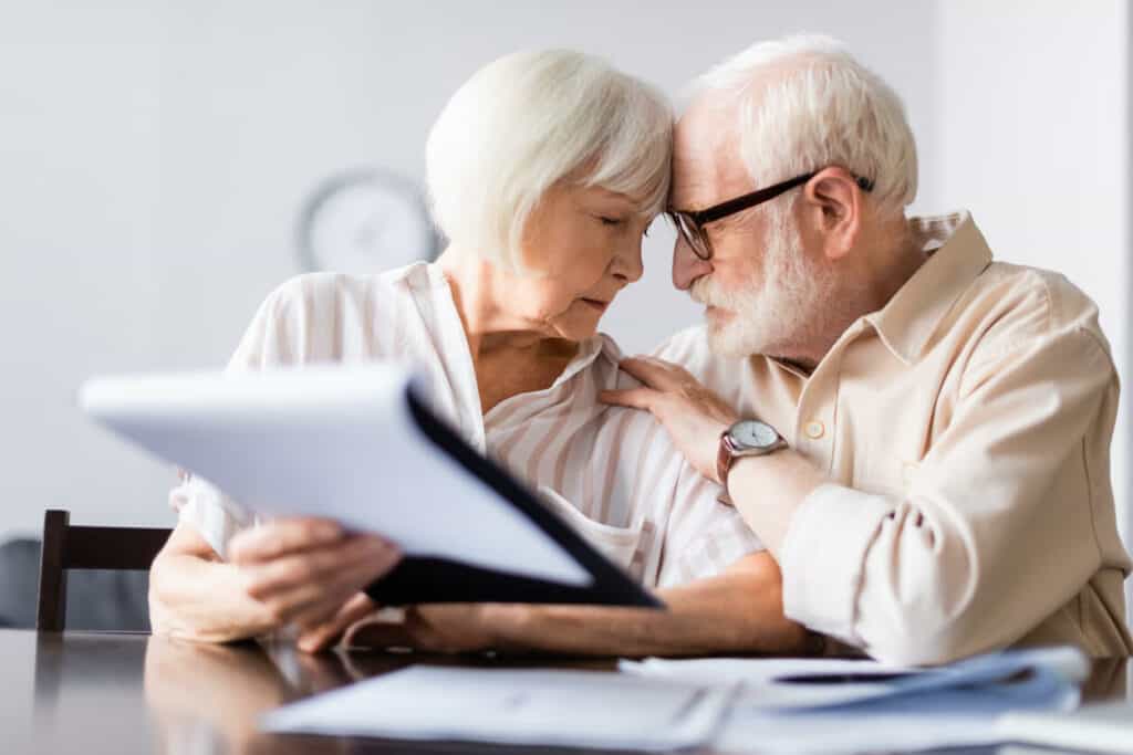 an older couple stressed after reviewing their medical documents