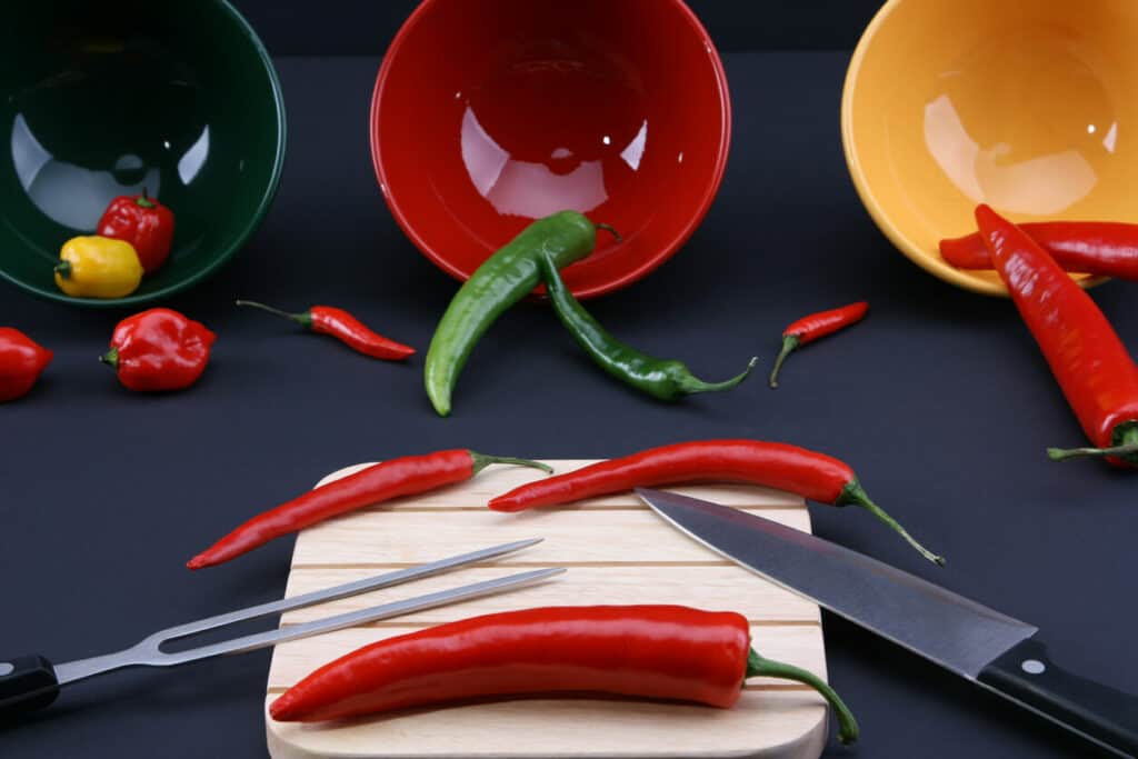what is the last taste bud to go - yellow, green, and red hot peppers with cutting utensils