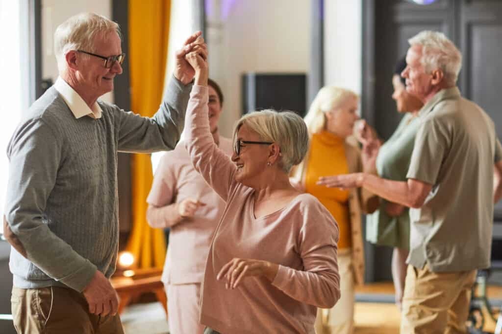 Senior exercise tips - dancing senior couples in a retirement home.