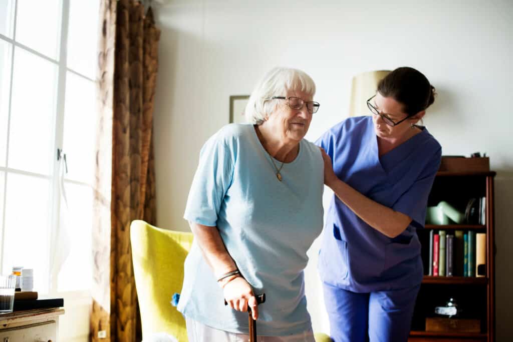 Caregiver providing in-home respite for an elderly woman