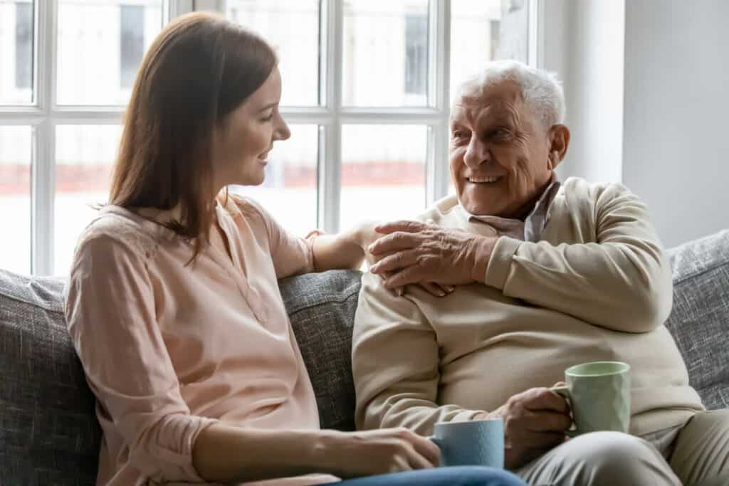 Daughter talking to her elderly father about home respite care