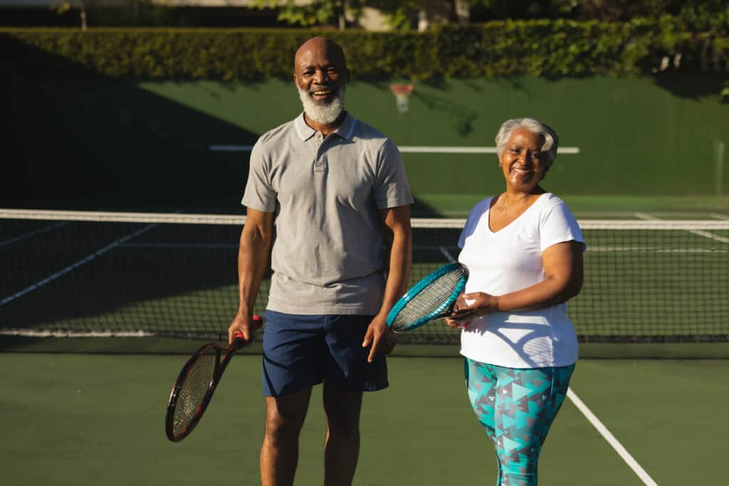 a happy couple enjoying exercising at the tennis court | best exercise