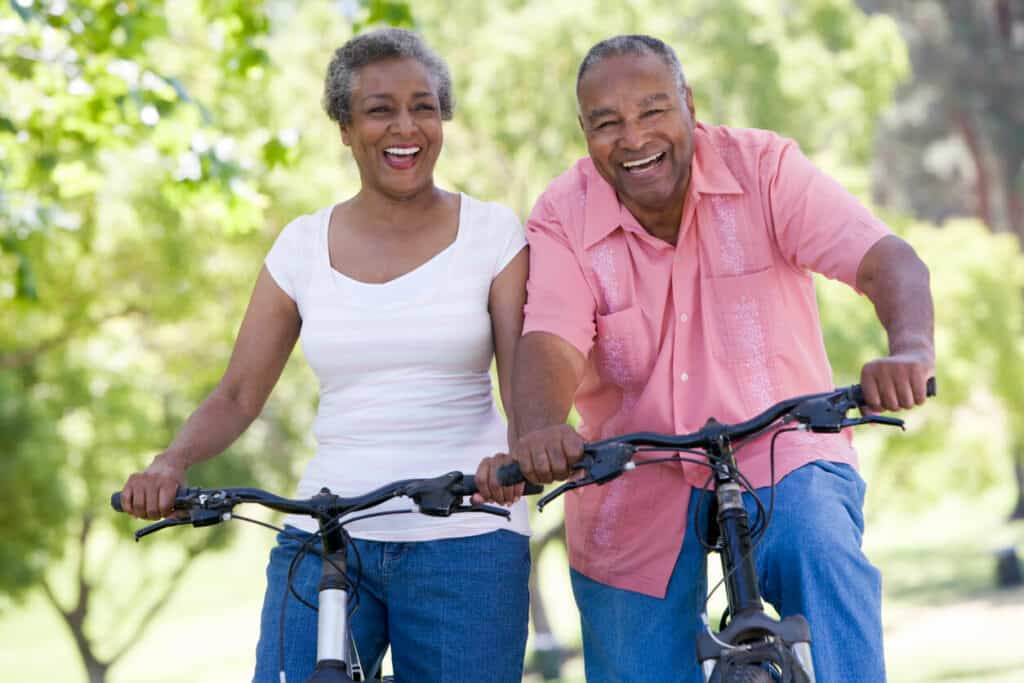 a happy couple enjoying cycling in their neighborhood |best exercises for women over 60